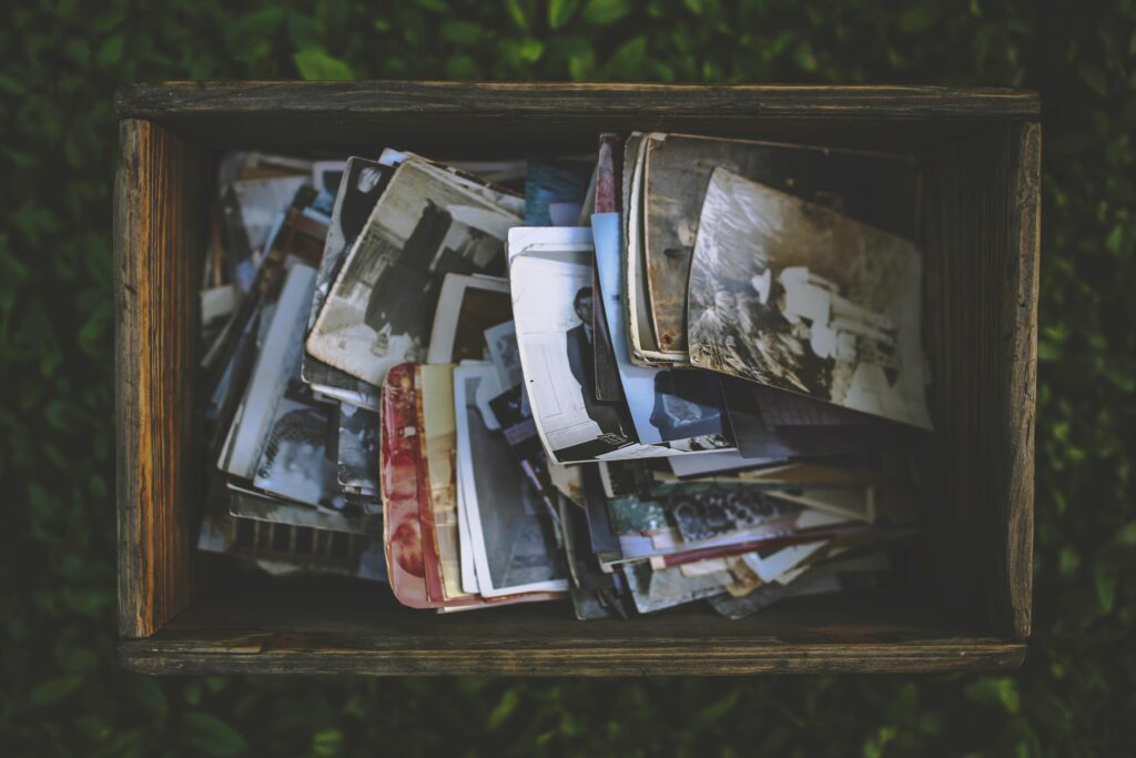 A nostalgic collection of vintage photos in an old wooden box.